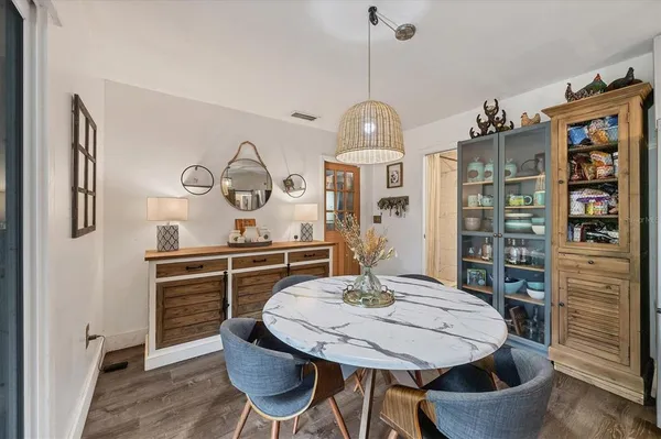 a living room with furniture a bookshelf and a chandelier