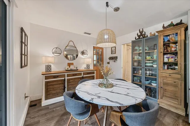 a living room with furniture a bookshelf and a chandelier