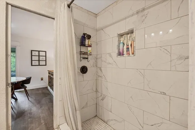 a bedroom with a bed and a dresser next to a window