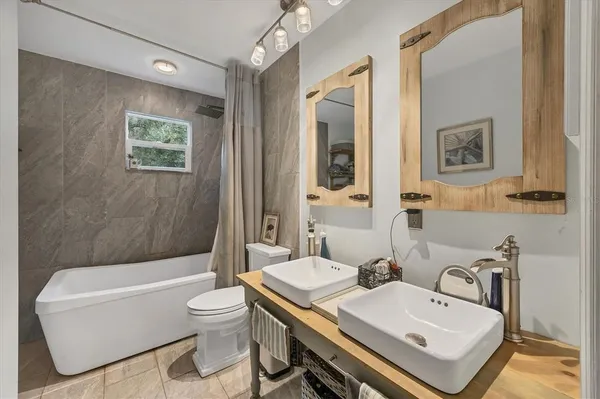 a living room with furniture a window and a flat screen tv