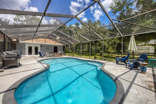 a backyard of a house with table and chairs