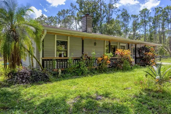 a view of outdoor space with deck and yard