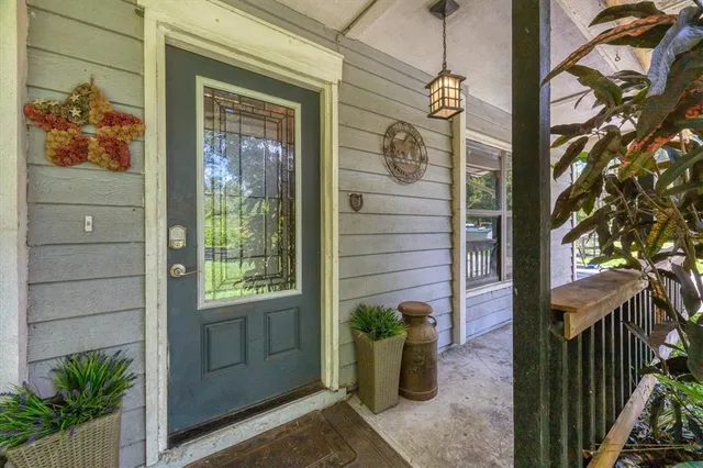 a view of a kitchen with furniture and wooden floor