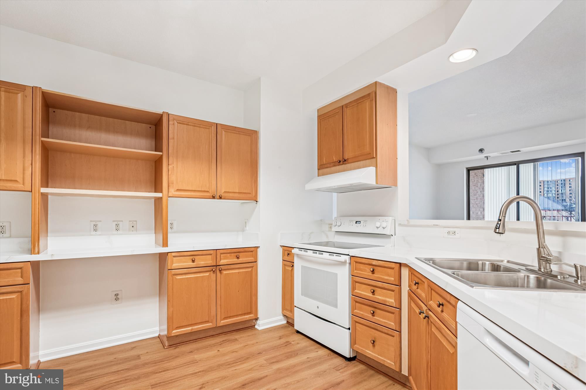 3210 North Leisure World Boulevard, Unit 119 Silver Spring, MD 20906 - Photo 13 of 76 a kitchen with granite countertop a sink cabinets stainless steel appliances and a window