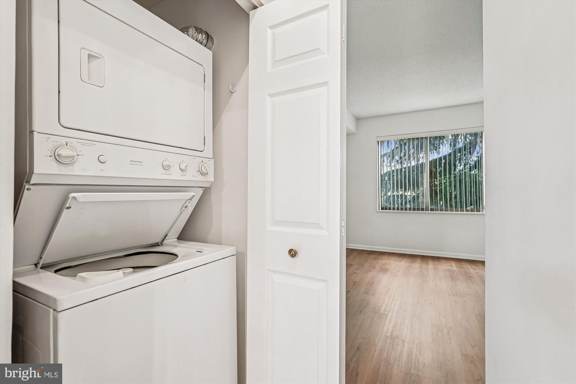3210 North Leisure World Boulevard, Unit 119 Silver Spring, MD 20906 - Photo 33 of 76 a view of washer and dryer with wooden floor