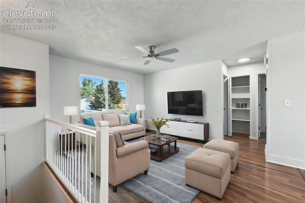 7033 Sequoyah Way Colorado Springs, CO 80915 - Photo 4 of 20 a living room with furniture and a flat screen tv