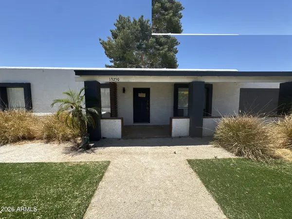 a view of a house with backyard porch and sitting area