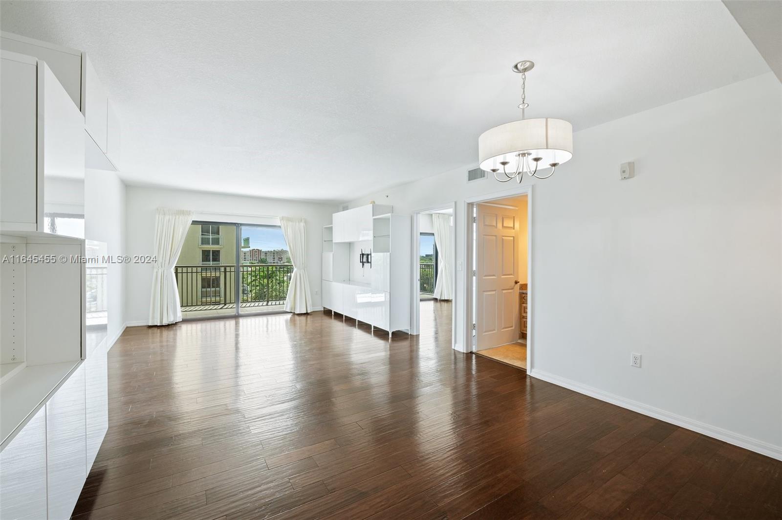 3530 Southwest 22nd Street, Unit 713 Miami, FL 33145 - Photo 15 of 41 a view of an empty room with wooden floor and a window