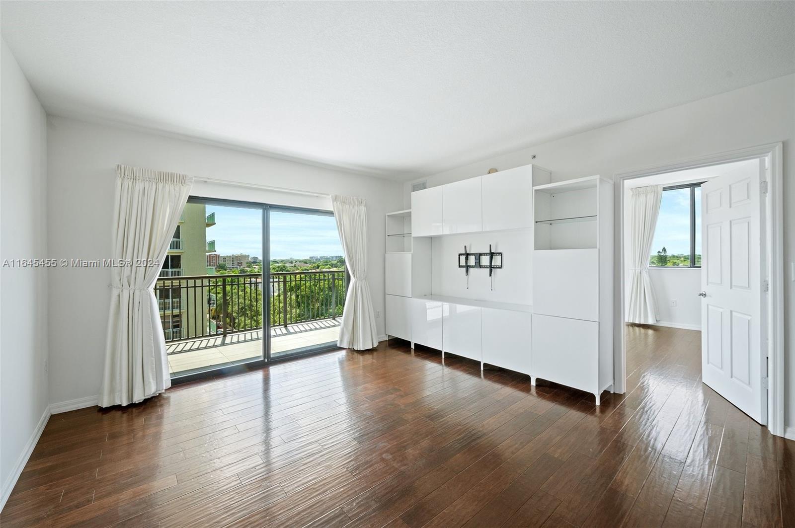 3530 Southwest 22nd Street, Unit 713 Miami, FL 33145 - Photo 16 of 41 an empty room with wooden floor and windows