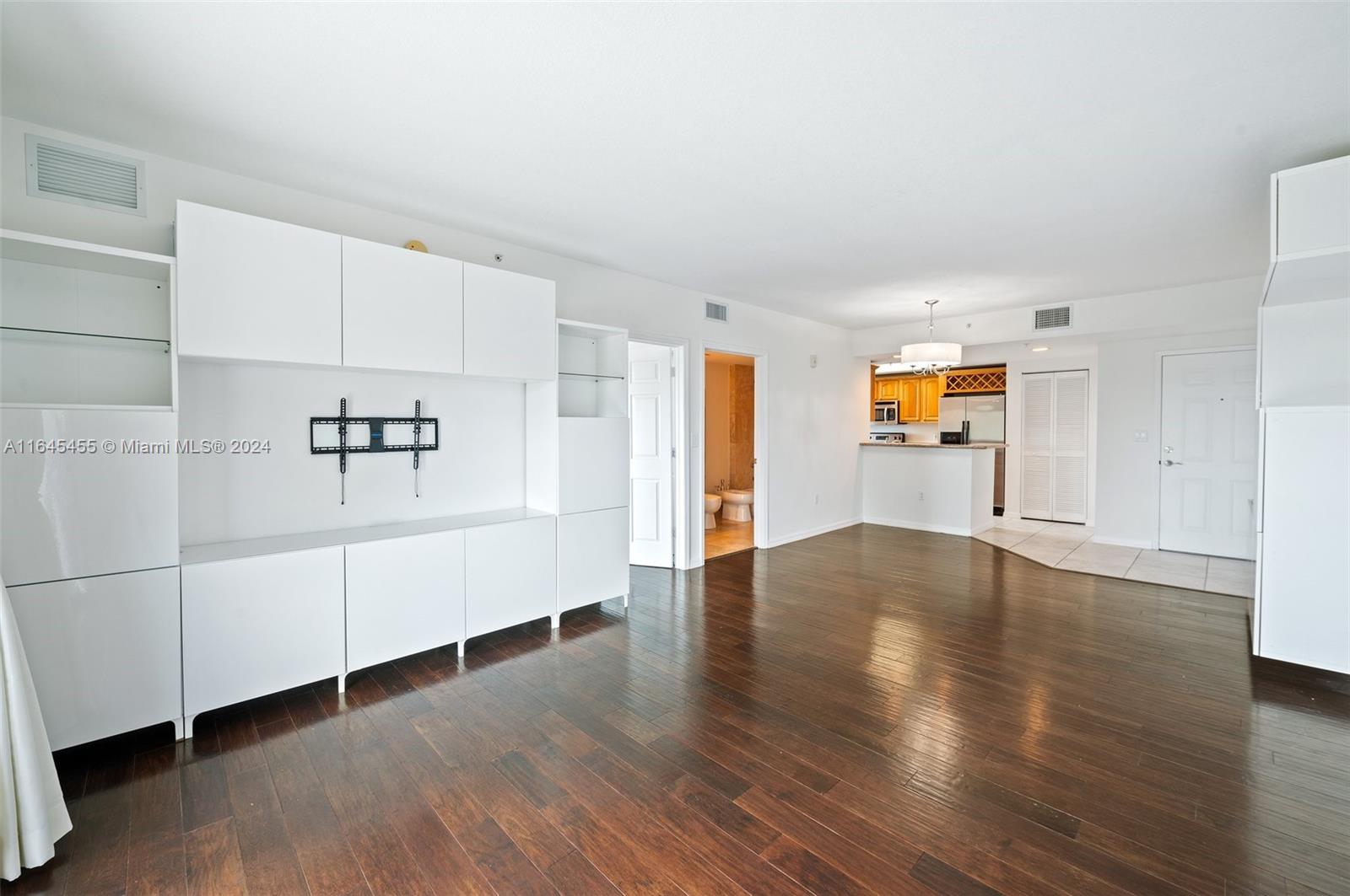 3530 Southwest 22nd Street, Unit 713 Miami, FL 33145 - Photo 17 of 41 an empty room with wooden floor and windows