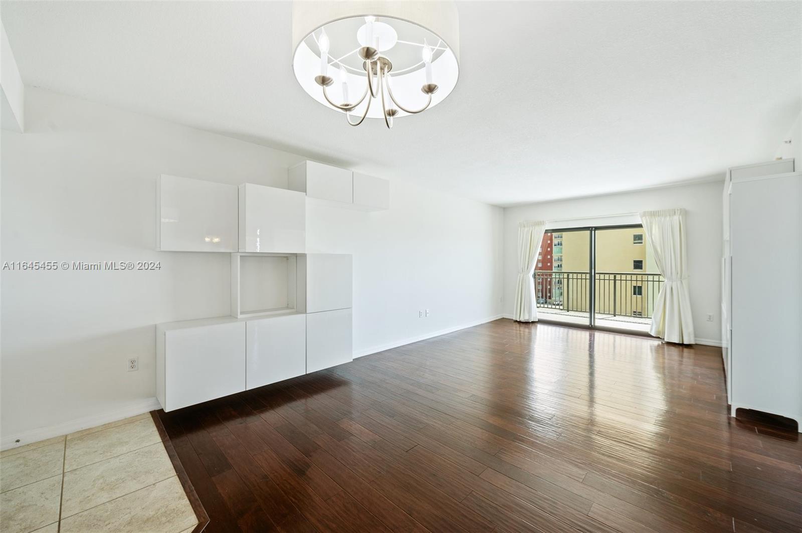 3530 Southwest 22nd Street, Unit 713 Miami, FL 33145 - Photo 18 of 41 a view of an empty room with wooden floor and windows