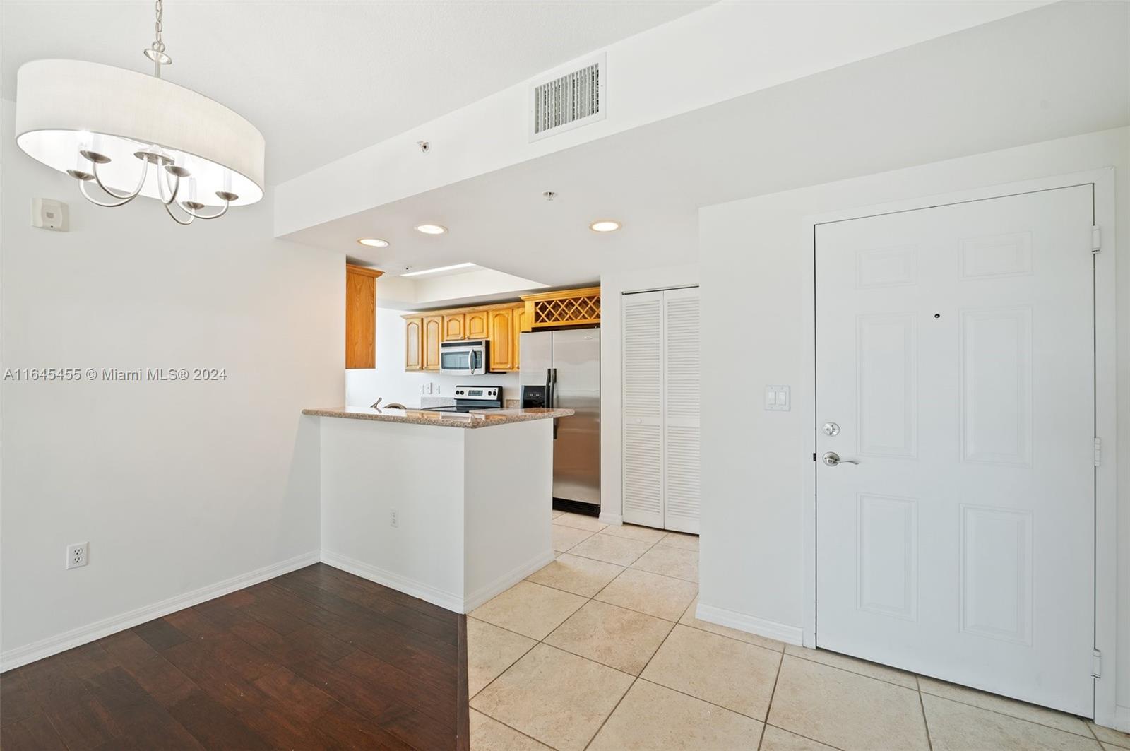 3530 Southwest 22nd Street, Unit 713 Miami, FL 33145 - Photo 20 of 41 a kitchen with white cabinets and white appliances