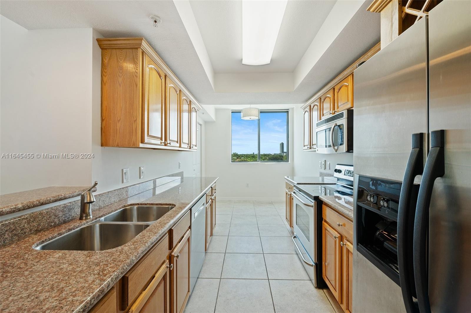 3530 Southwest 22nd Street, Unit 713 Miami, FL 33145 - Photo 22 of 41 a kitchen with stainless steel appliances granite countertop a sink and a refrigerator