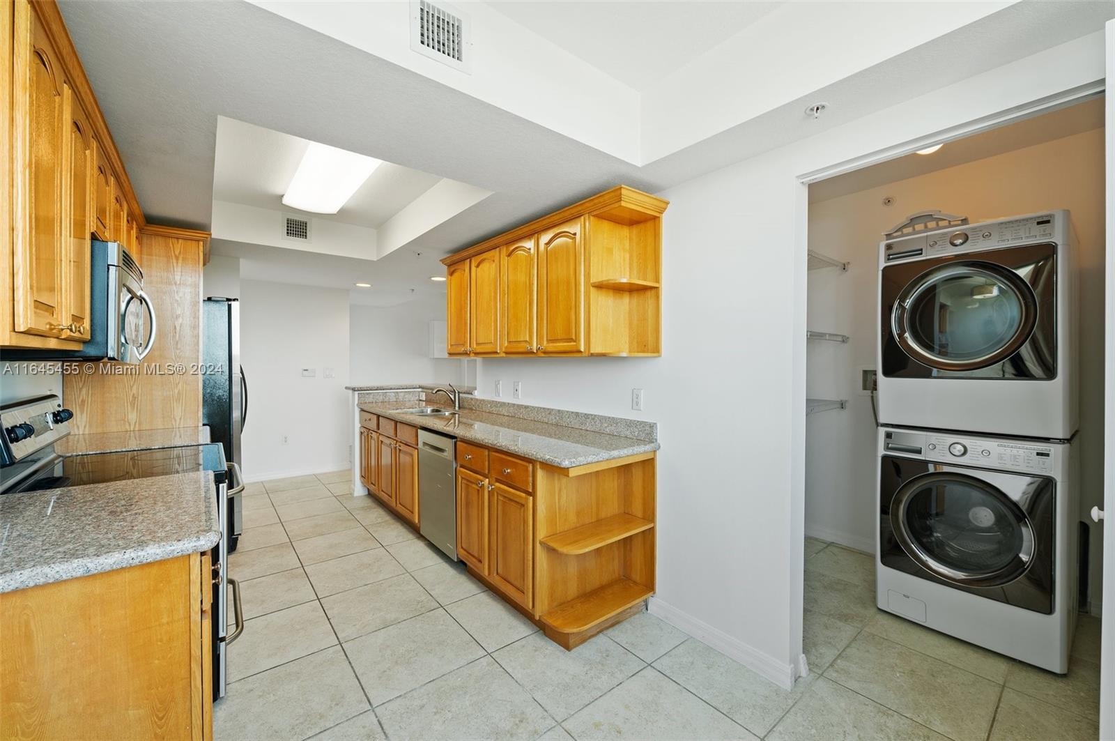 3530 Southwest 22nd Street, Unit 713 Miami, FL 33145 - Photo 25 of 41 a kitchen with stainless steel appliances granite countertop a sink and a stove top oven