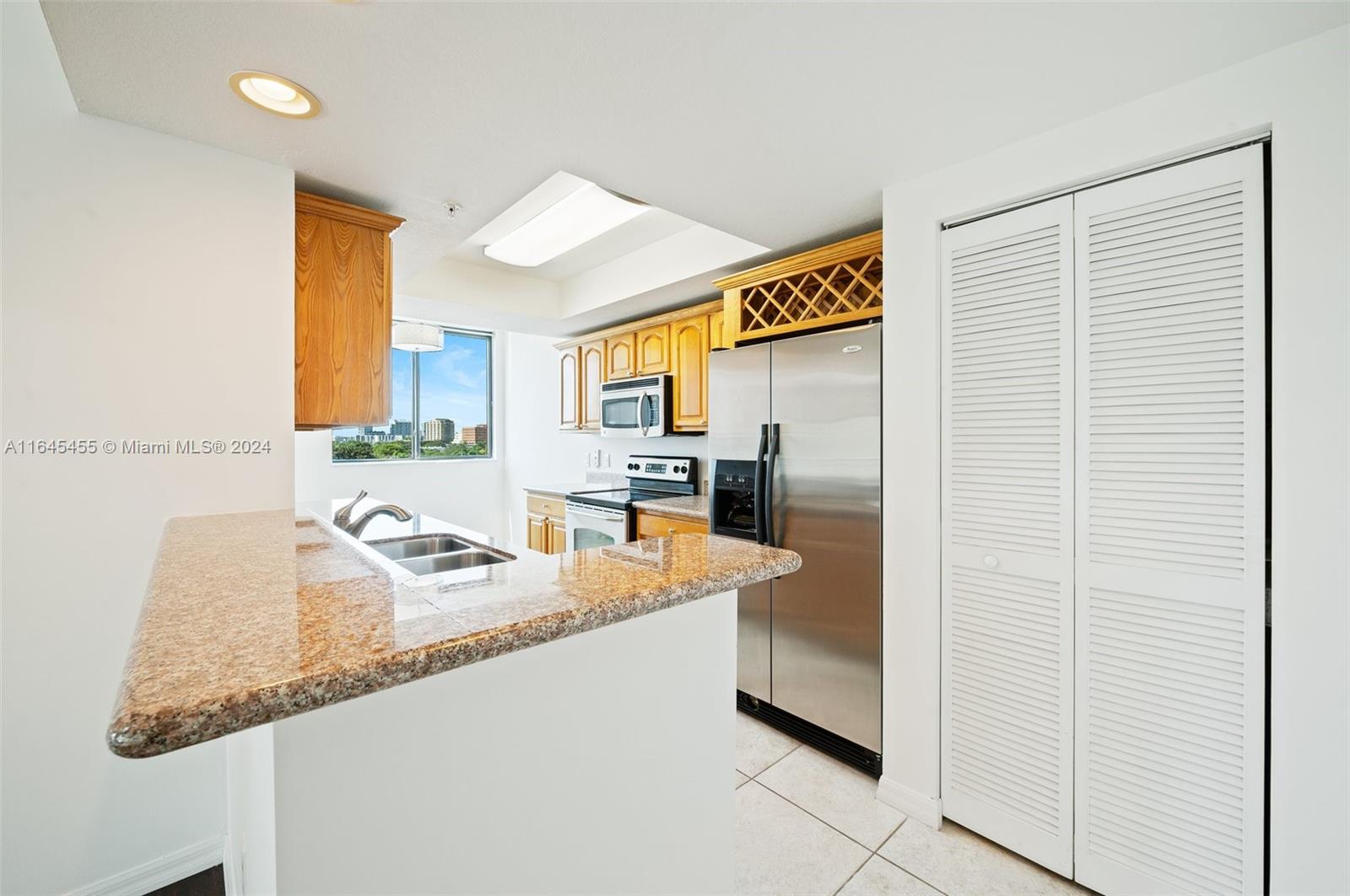 3530 Southwest 22nd Street, Unit 713 Miami, FL 33145 - Photo 26 of 41 a kitchen with granite countertop refrigerator and sink