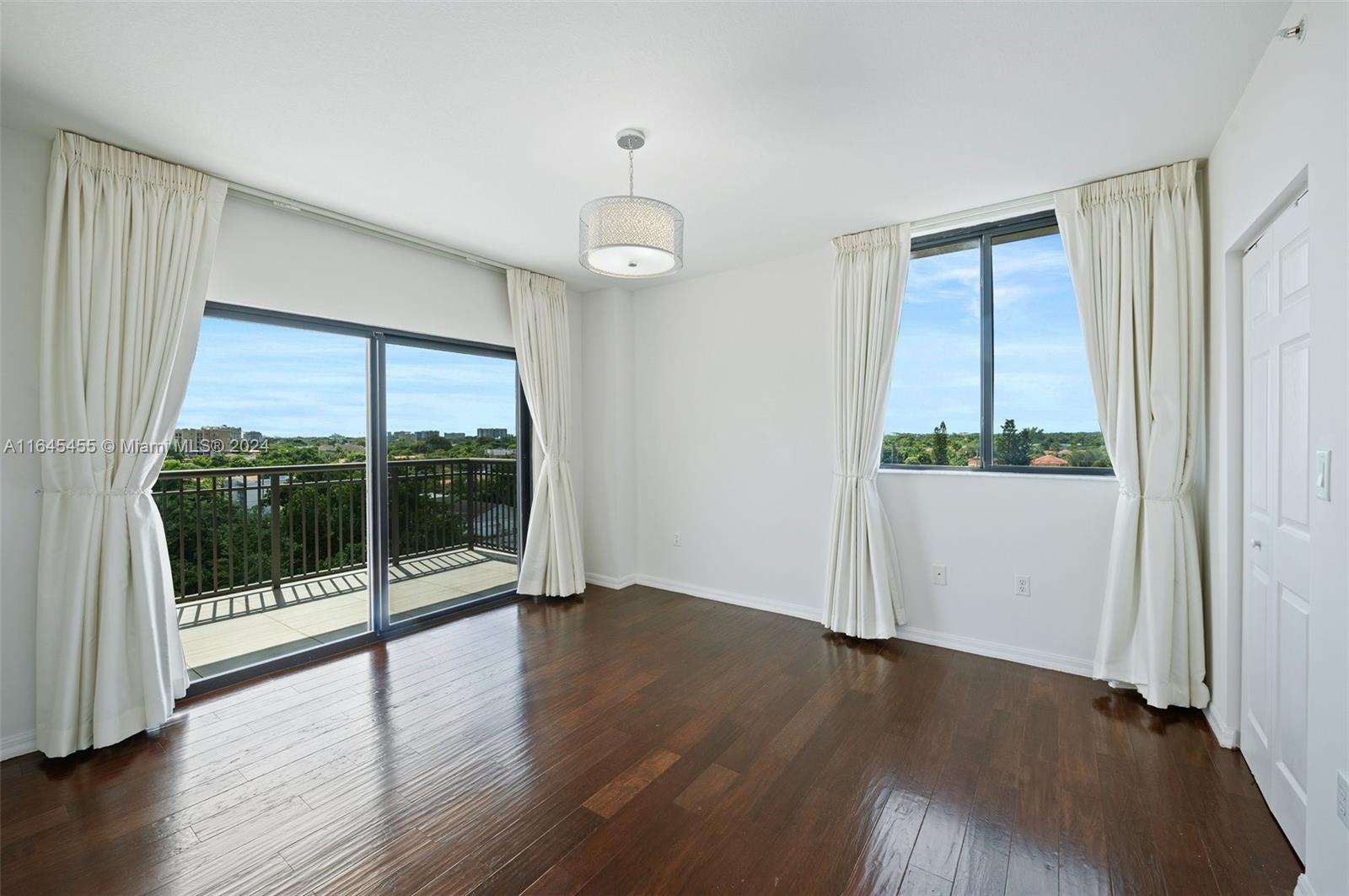 3530 Southwest 22nd Street, Unit 713 Miami, FL 33145 - Photo 28 of 41 an empty room with wooden floor and windows
