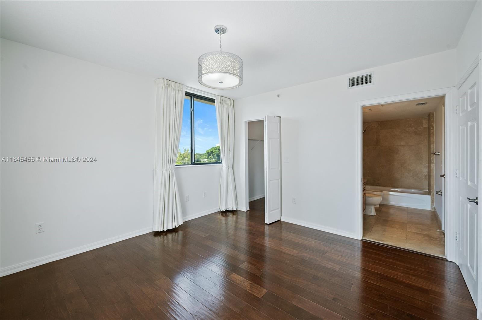 3530 Southwest 22nd Street, Unit 713 Miami, FL 33145 - Photo 29 of 41 an empty room with wooden floor and window