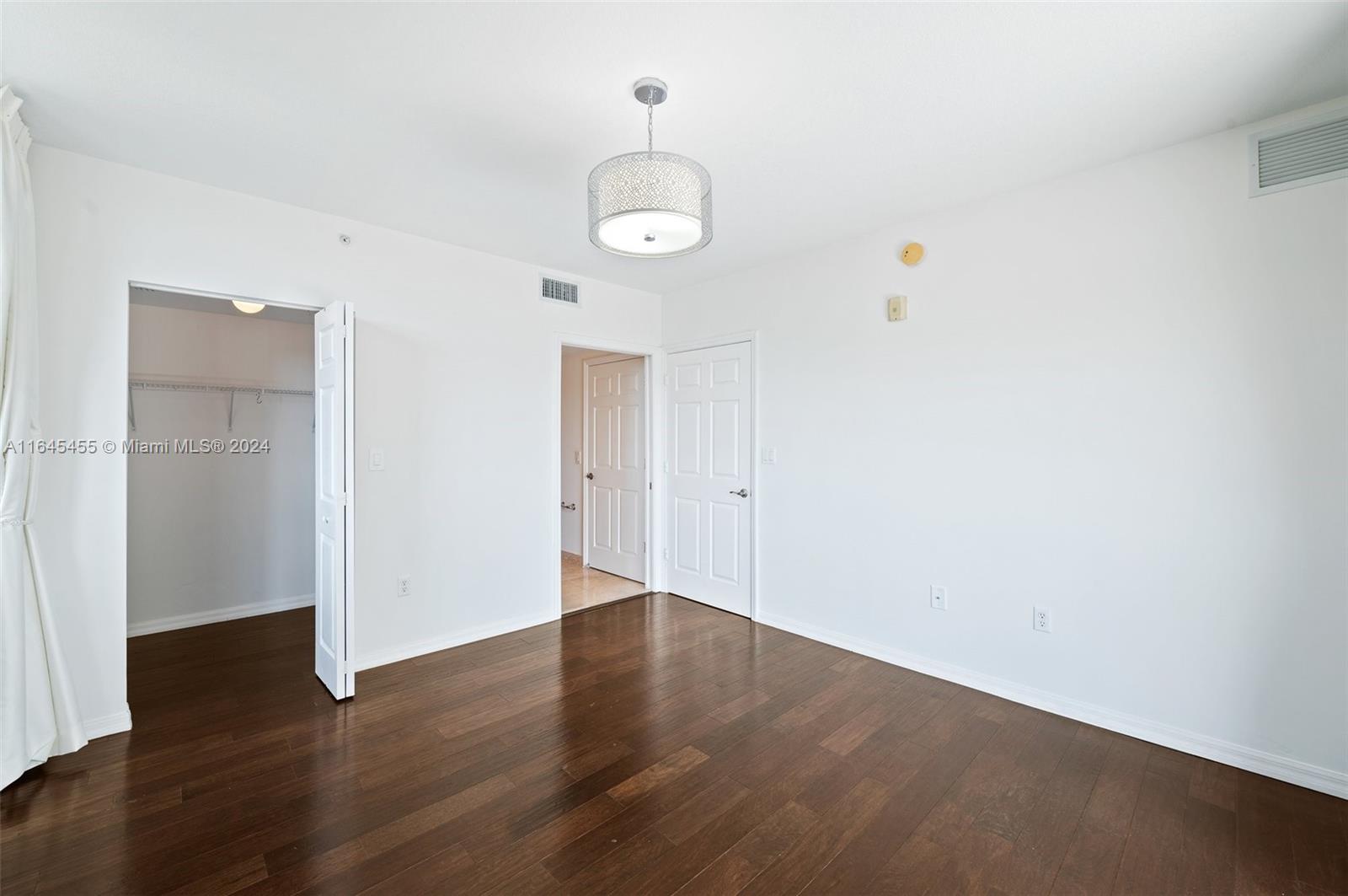 3530 Southwest 22nd Street, Unit 713 Miami, FL 33145 - Photo 30 of 41 an empty room with wooden floor and windows
