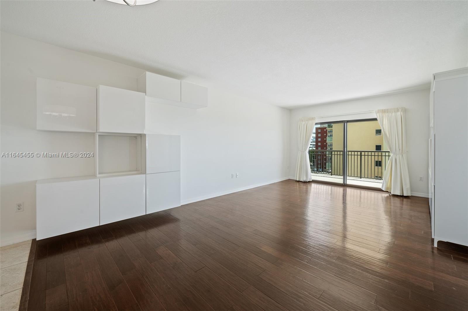 3530 Southwest 22nd Street, Unit 713 Miami, FL 33145 - Photo 34 of 41 an empty room with wooden floor and windows