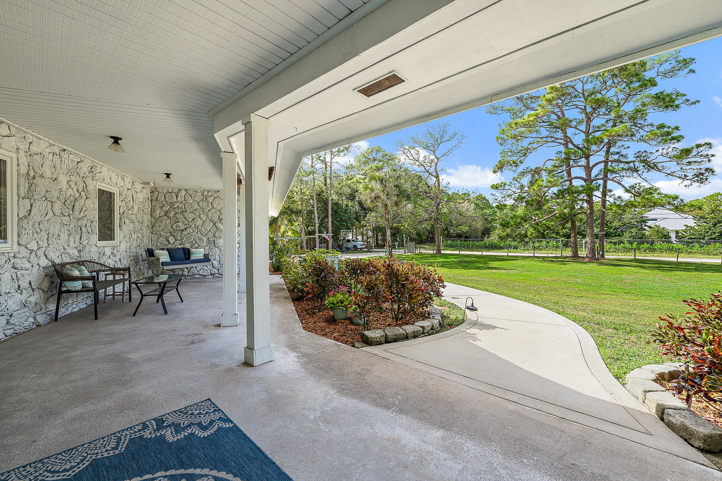 17696 Winterhawk Trail Jupiter, FL 33478 - Photo 14 of 21 a view of a porch with furniture and garden