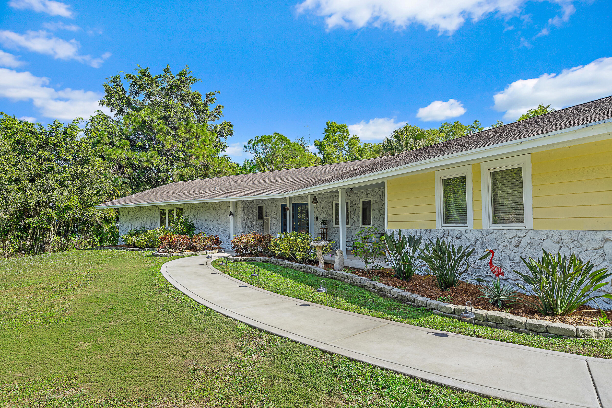17696 Winterhawk Trail Jupiter, FL 33478 - Photo 20 of 21 a view of a house with a yard