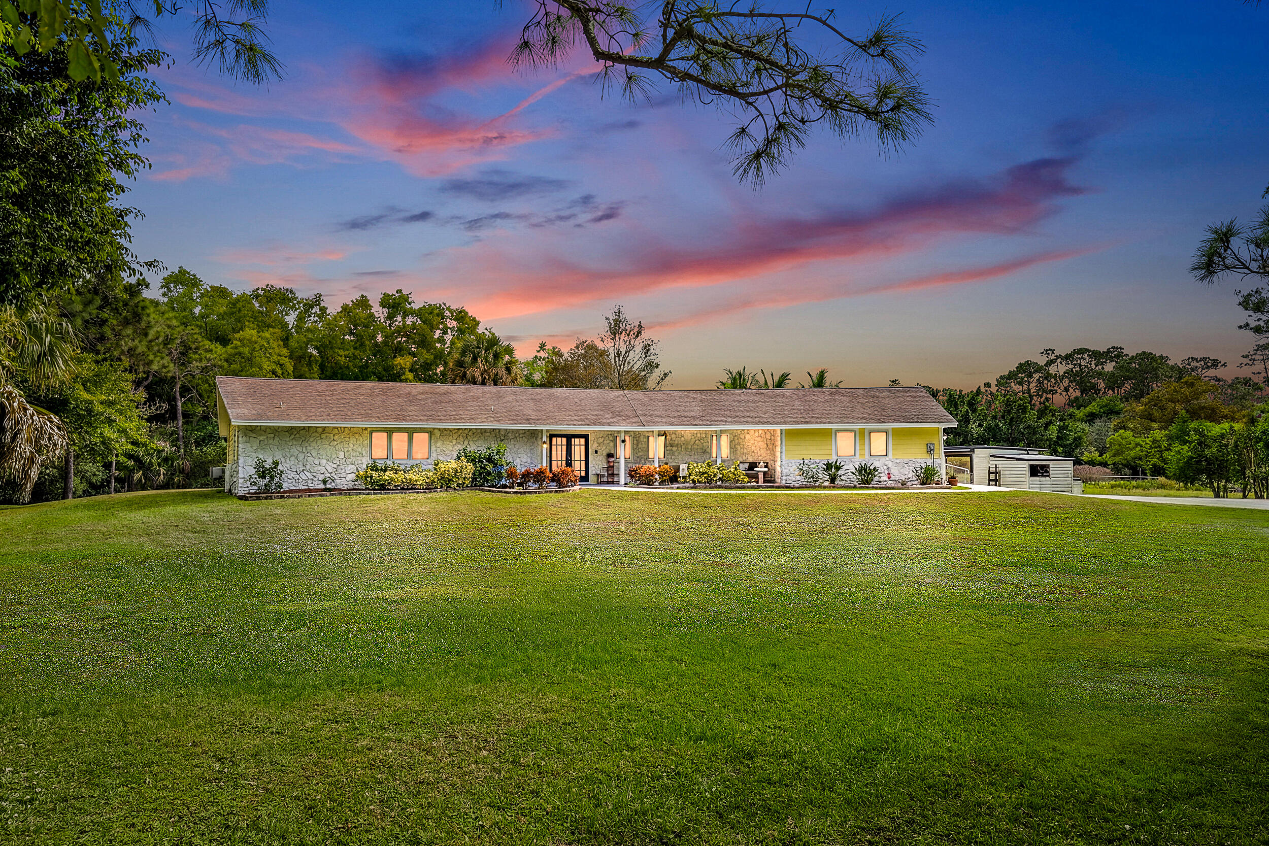 17696 Winterhawk Trail Jupiter, FL 33478 - Photo 2 of 21 a view of a big room with a big yard