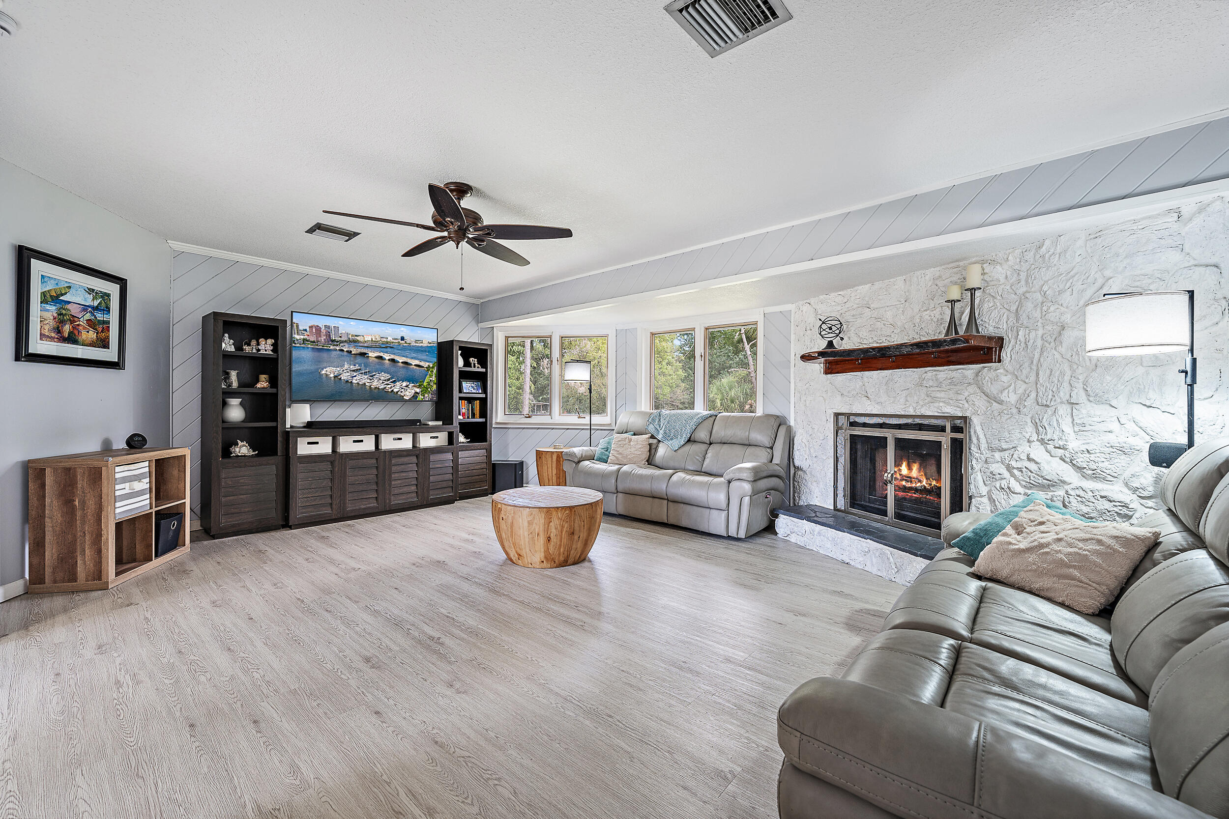 17696 Winterhawk Trail Jupiter, FL 33478 - Photo 5 of 21 a living room with furniture a fireplace and a flat screen tv