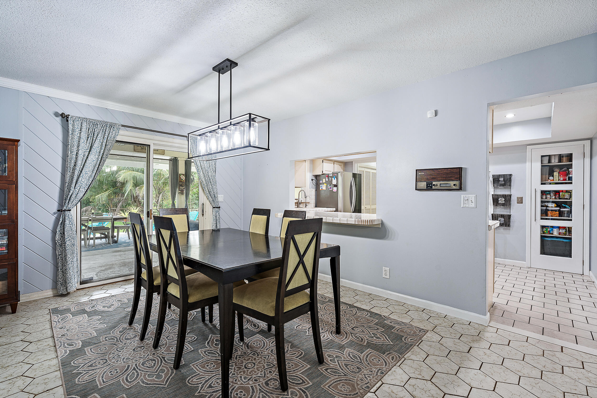 17696 Winterhawk Trail Jupiter, FL 33478 - Photo 6 of 21 a dining room with furniture a chandelier and window