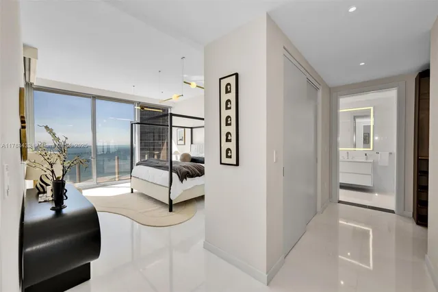 a bedroom with a bed and large window