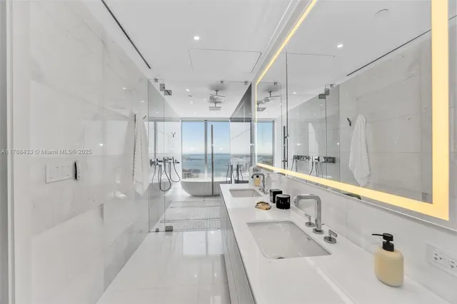 a bathroom with a bathtub and a glass door shower