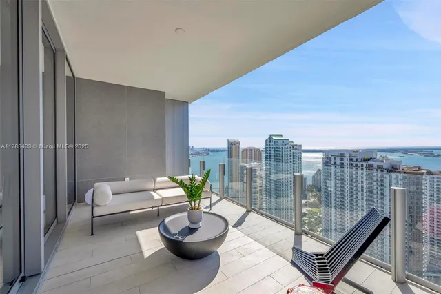 a balcony with table and chairs