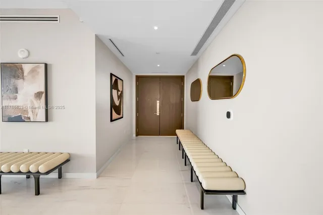a view of a hallway with seating area