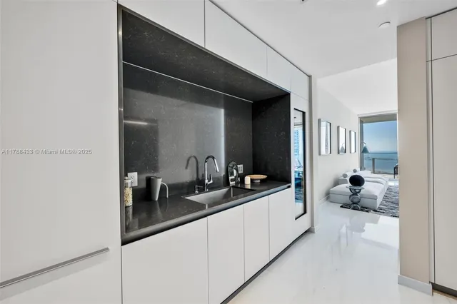 a kitchen with stainless steel appliances kitchen island granite countertop a sink and cabinets