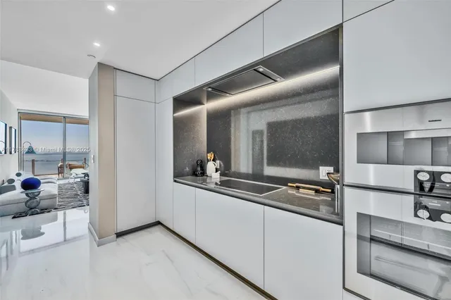 a dining room with furniture and a potted plant