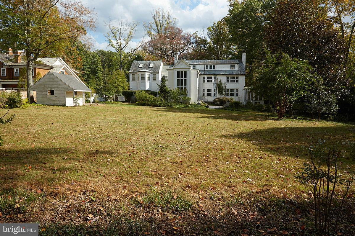 9108 Burning Tree Road Bethesda, MD 20817 - Photo 11 of 15 a front view of a house with a yard and trees