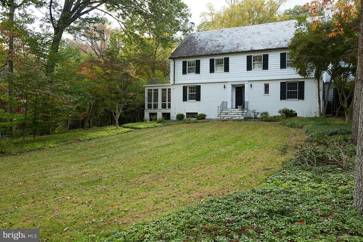 9108 Burning Tree Road Bethesda, MD 20817 - Photo 4 of 15 a view of a yard in front of a house with plants and large trees