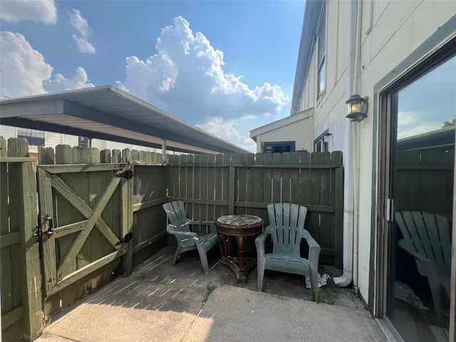 a view of a chair and tables in the balcony