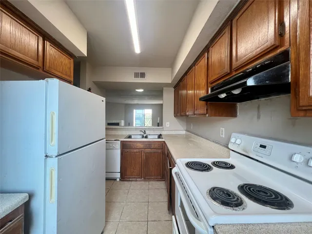 a kitchen with a refrigerator stove and cabinets