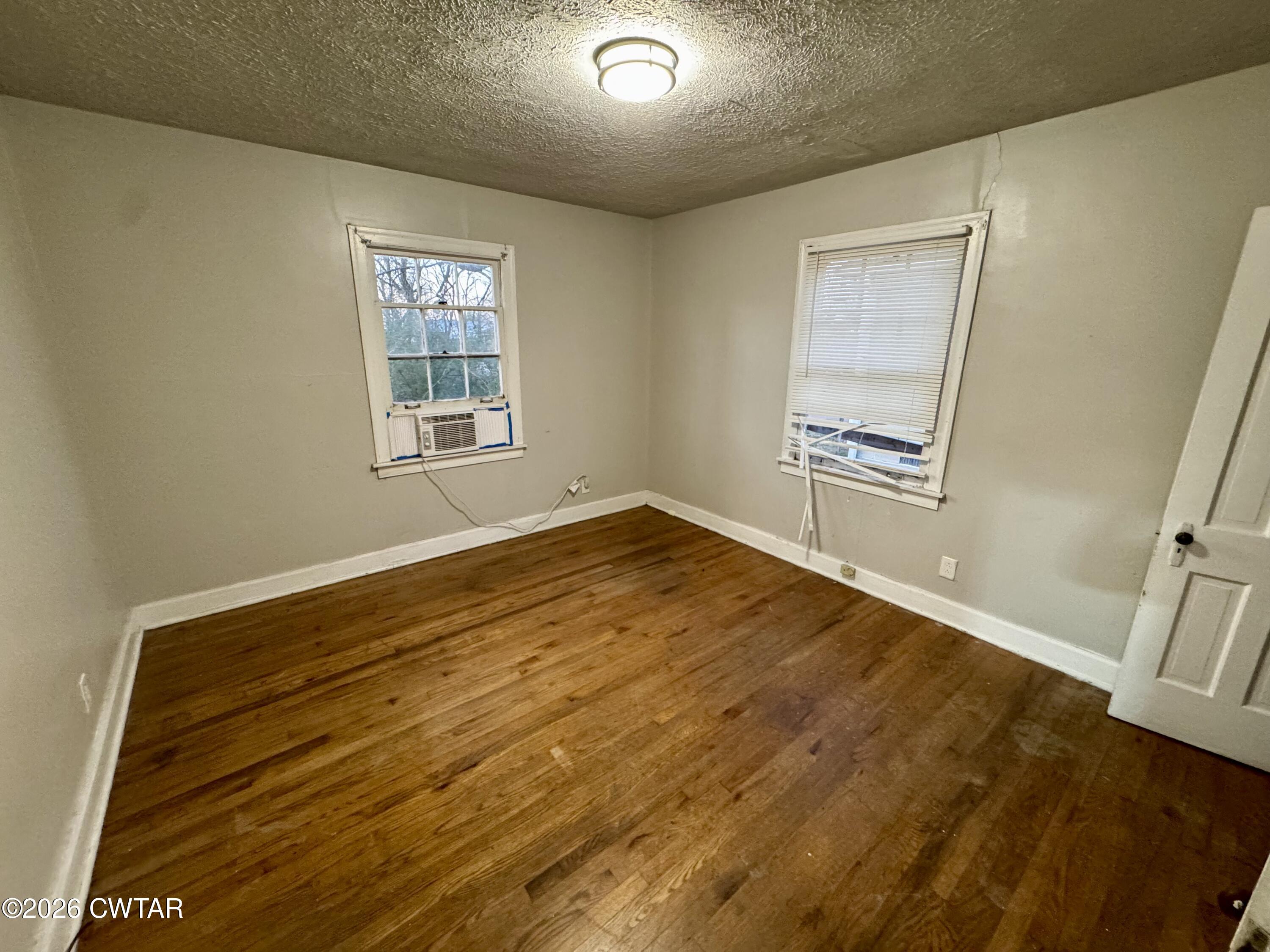 125 South Fairgrounds Street Jackson, TN 38301 - Photo 11 of 15 a view of empty room with wooden floor and fan