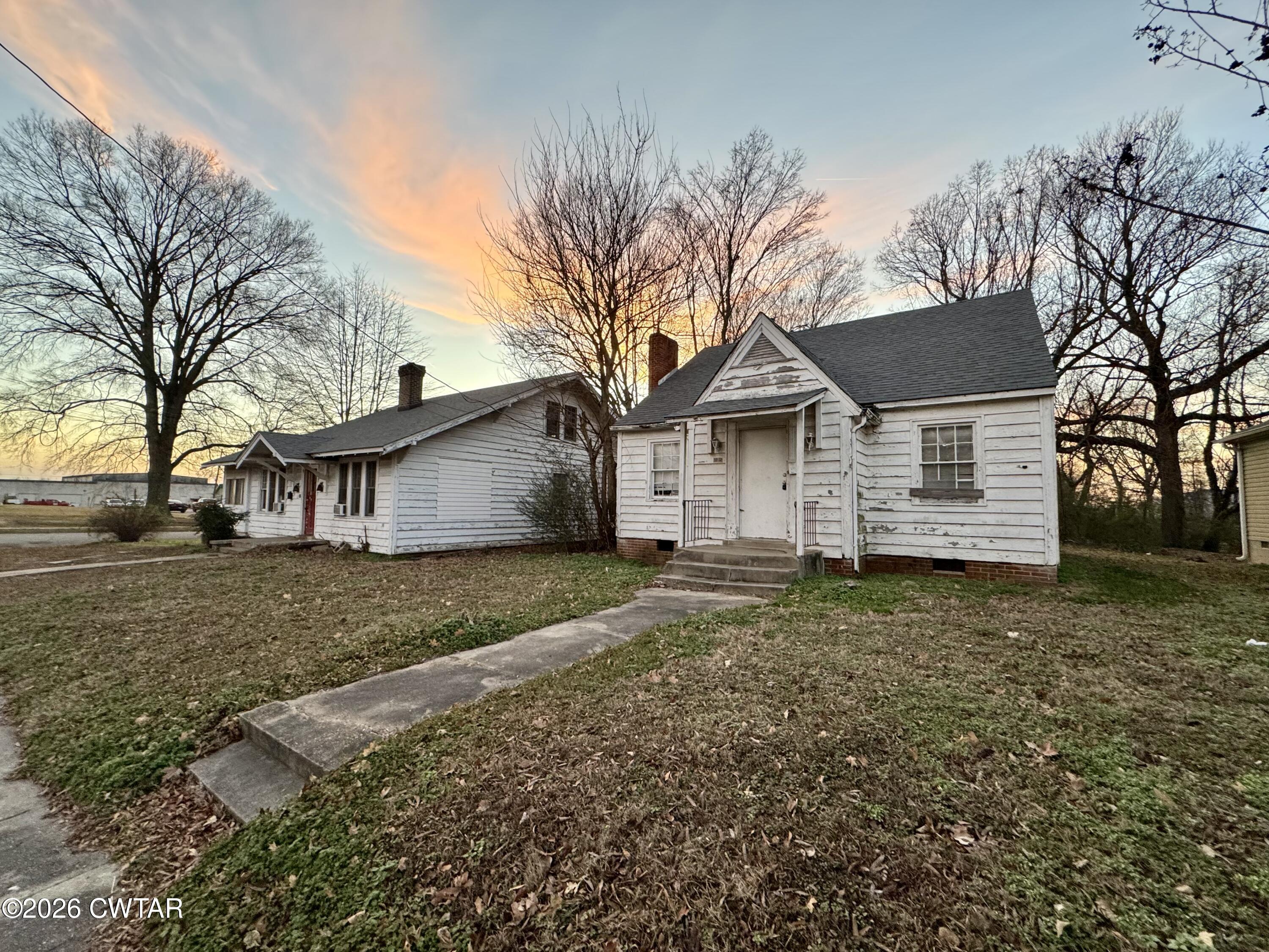 125 South Fairgrounds Street Jackson, TN 38301 - Photo 2 of 15 a view of a house with a yard covered in the forest