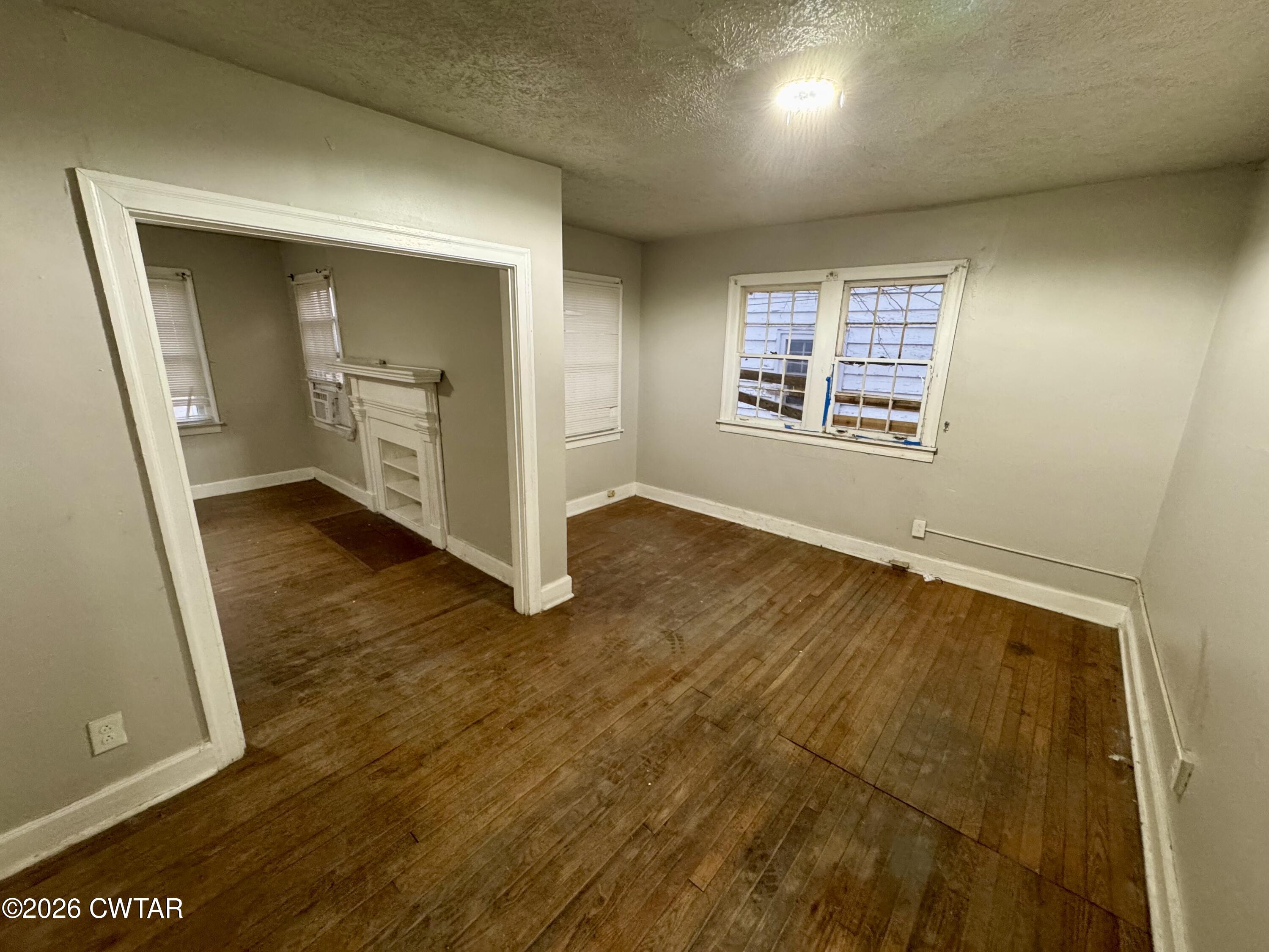 125 South Fairgrounds Street Jackson, TN 38301 - Photo 5 of 15 an empty room with wooden floor and windows