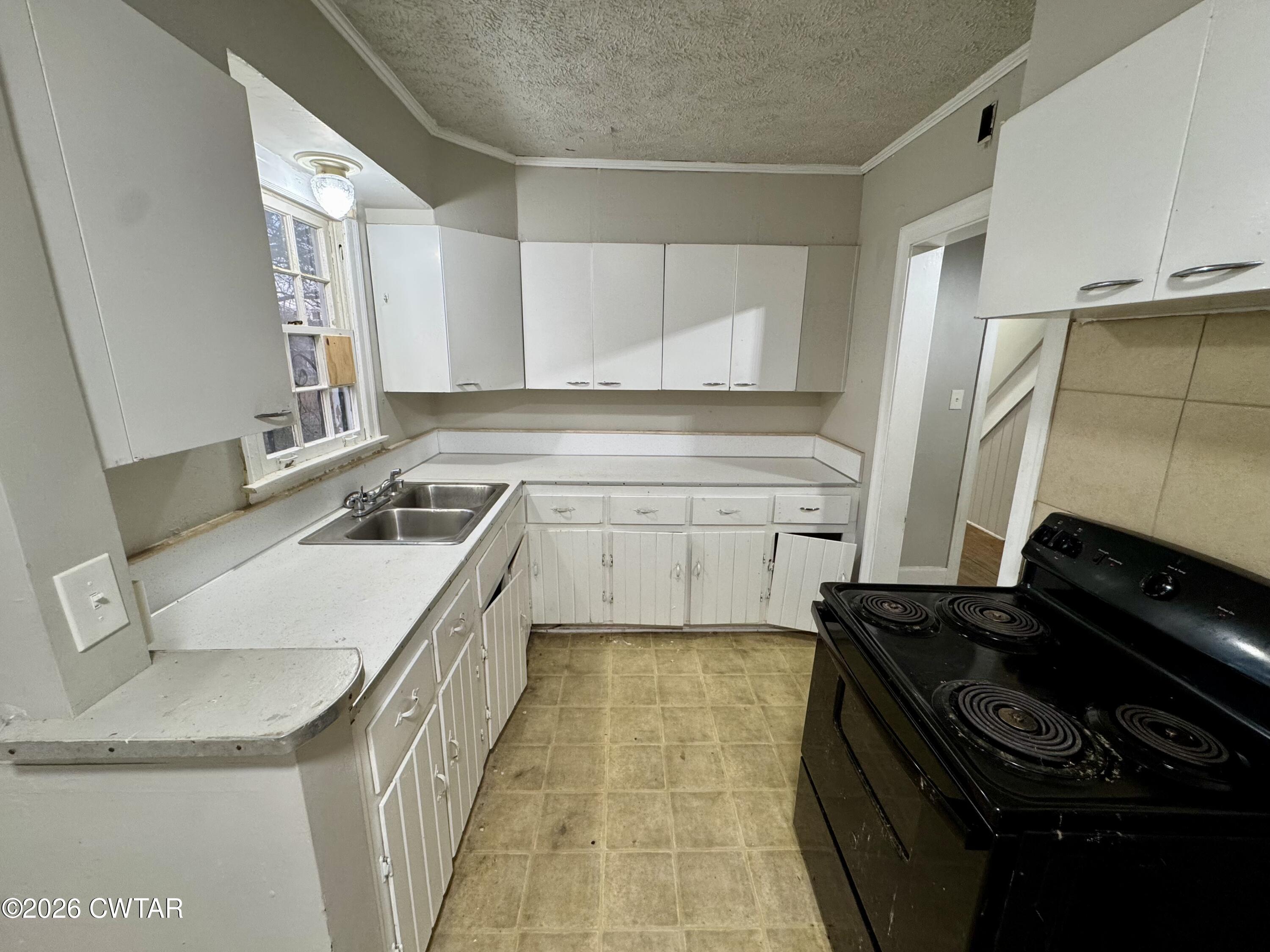 125 South Fairgrounds Street Jackson, TN 38301 - Photo 7 of 15 a kitchen that has a sink and a stove