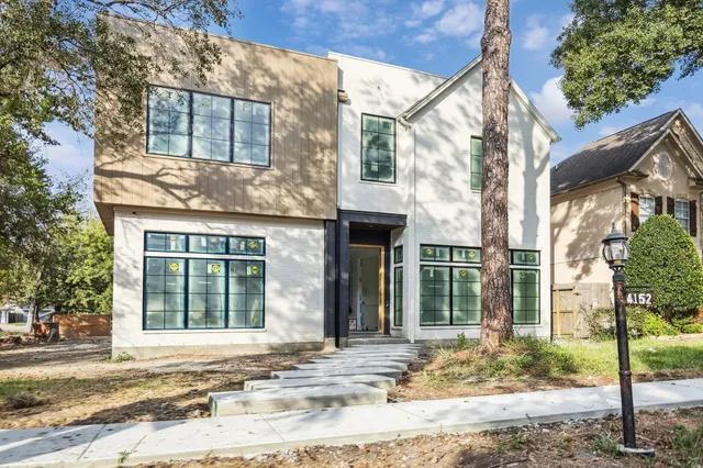 a bedroom with a large bed and a large window