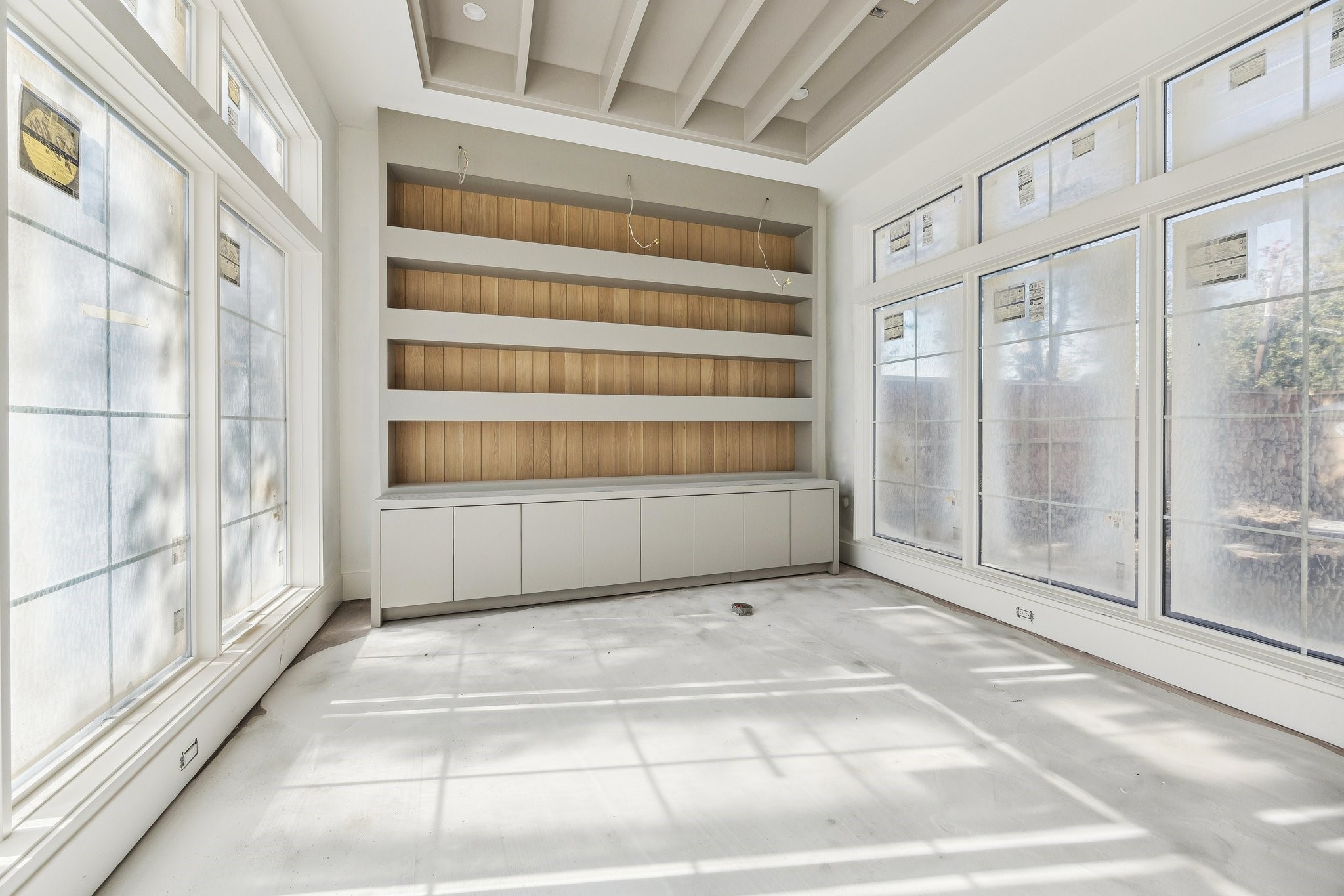 4152 Coleridge Street West University Place, TX 77005 - Photo 2 of 29 Located off the entrance of the home is a study with built-in shelving and cabinets. The ceiling has painted beams and there are windows on both the north and south side of the room.