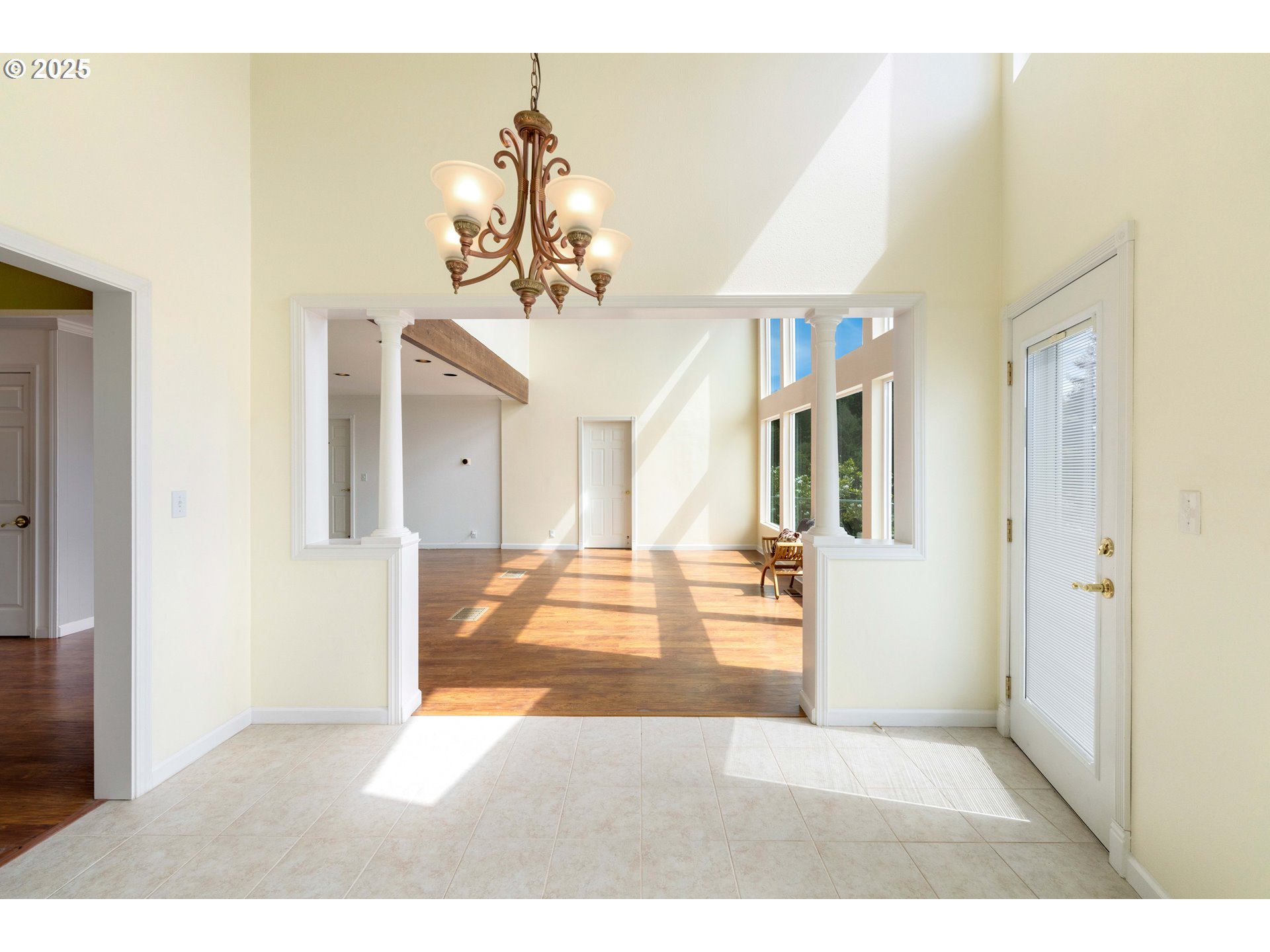 66599 Quail Road North Bend, OR 97459 - Photo 15 of 45 a view of a livingroom with a dinning area wooden floor and chandelier