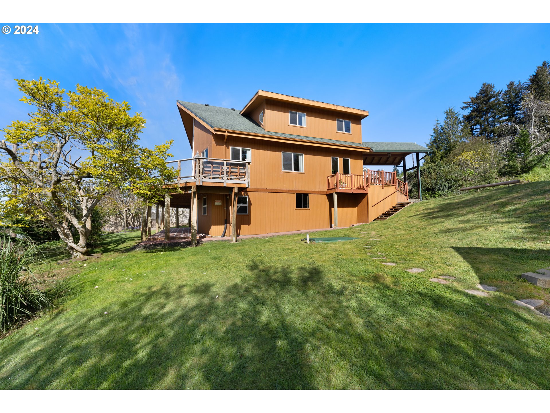 66599 Quail Road North Bend, OR 97459 - Photo 2 of 45 a house view with a outdoor space