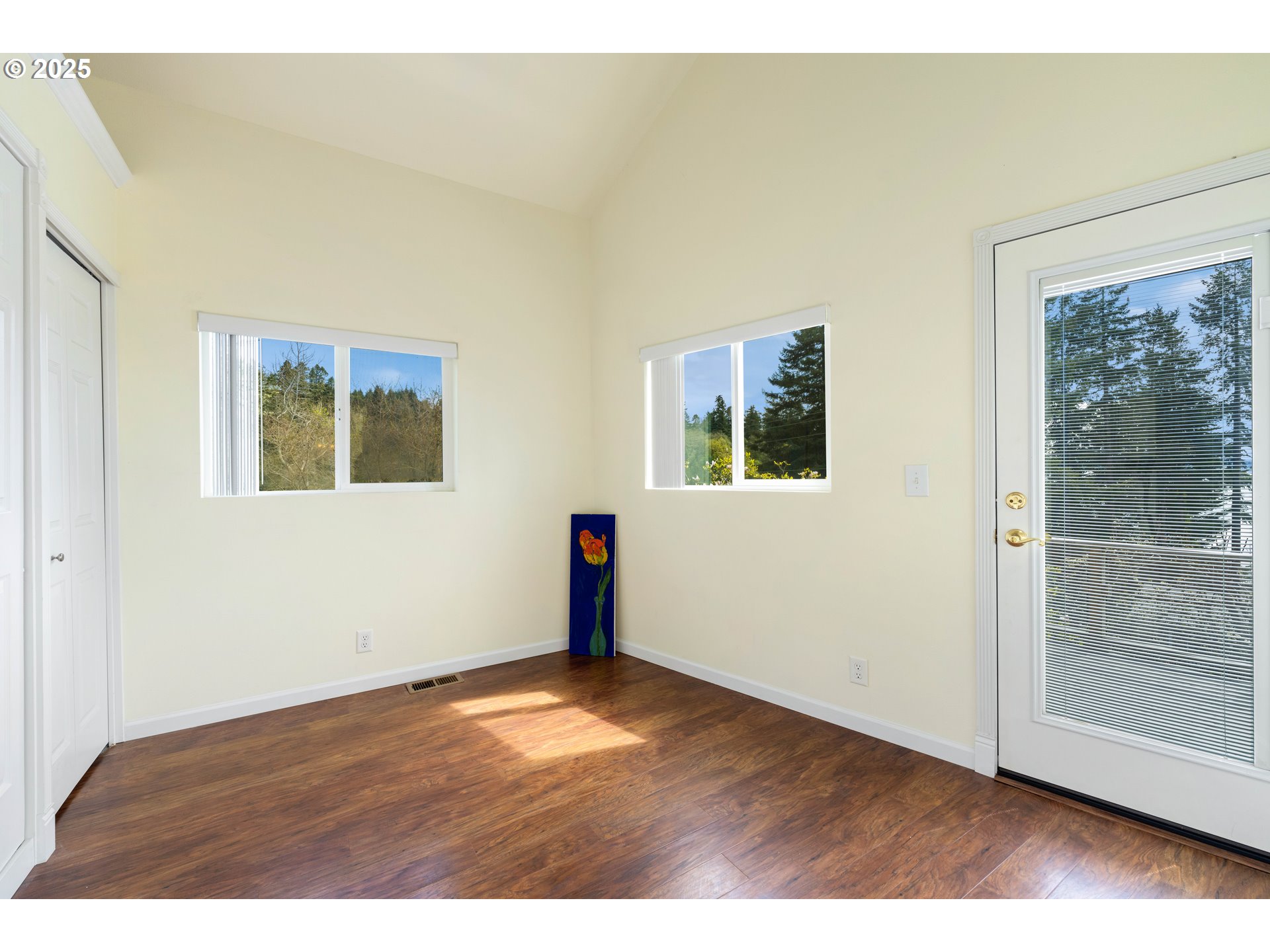 66599 Quail Road North Bend, OR 97459 - Photo 21 of 45 a view of an empty room with wooden floor and a window