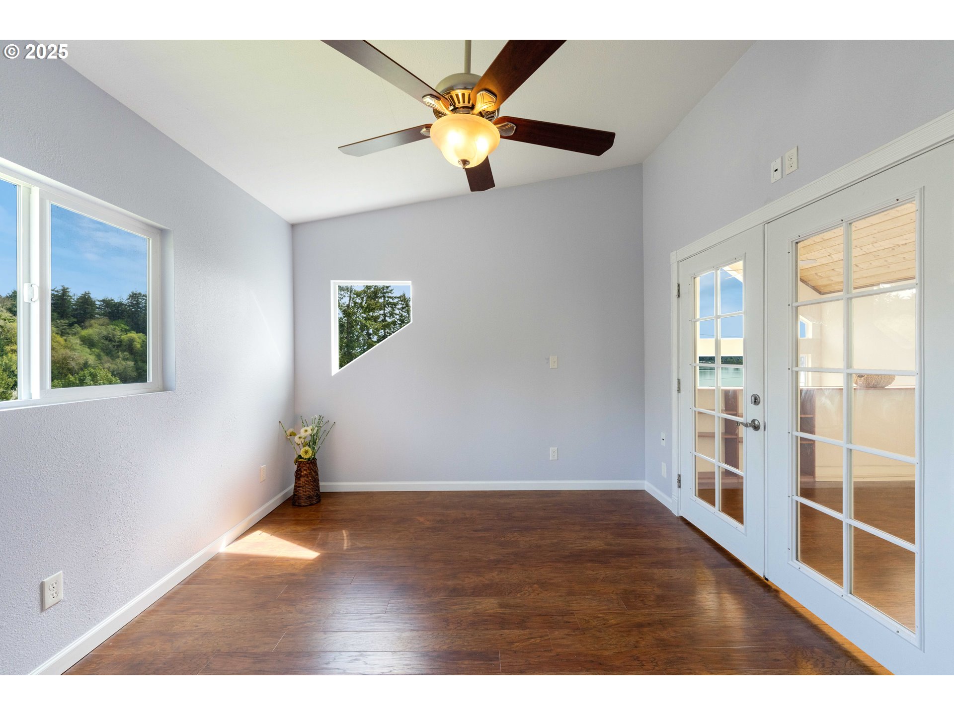66599 Quail Road North Bend, OR 97459 - Photo 29 of 45 a view of an empty room with window and wooden floor