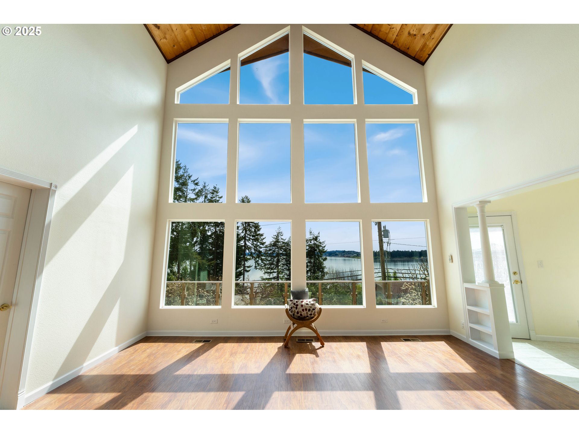 66599 Quail Road North Bend, OR 97459 - Photo 4 of 45 a view of an empty room with wooden floor and a fireplace