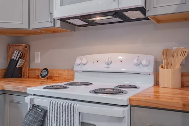 a dining room with furniture and a refrigerator